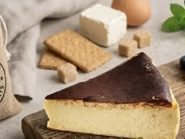 Slice of creamy Basque cheesecake with a deeply caramelized top