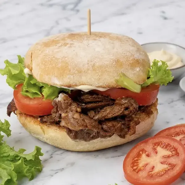 Skylark steak sandwich with lettuce, tomato and creamy sauce
