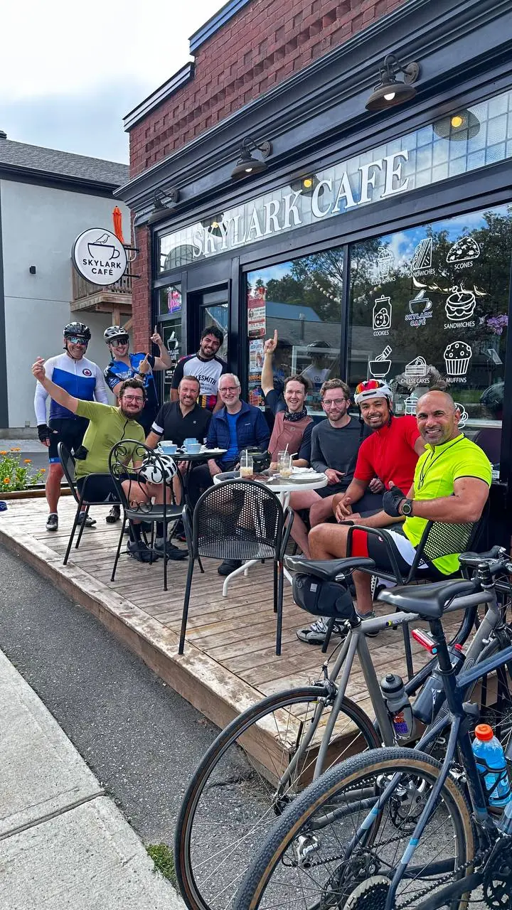 Cyclists sharing a patio break with their bikes outside Skylark Café