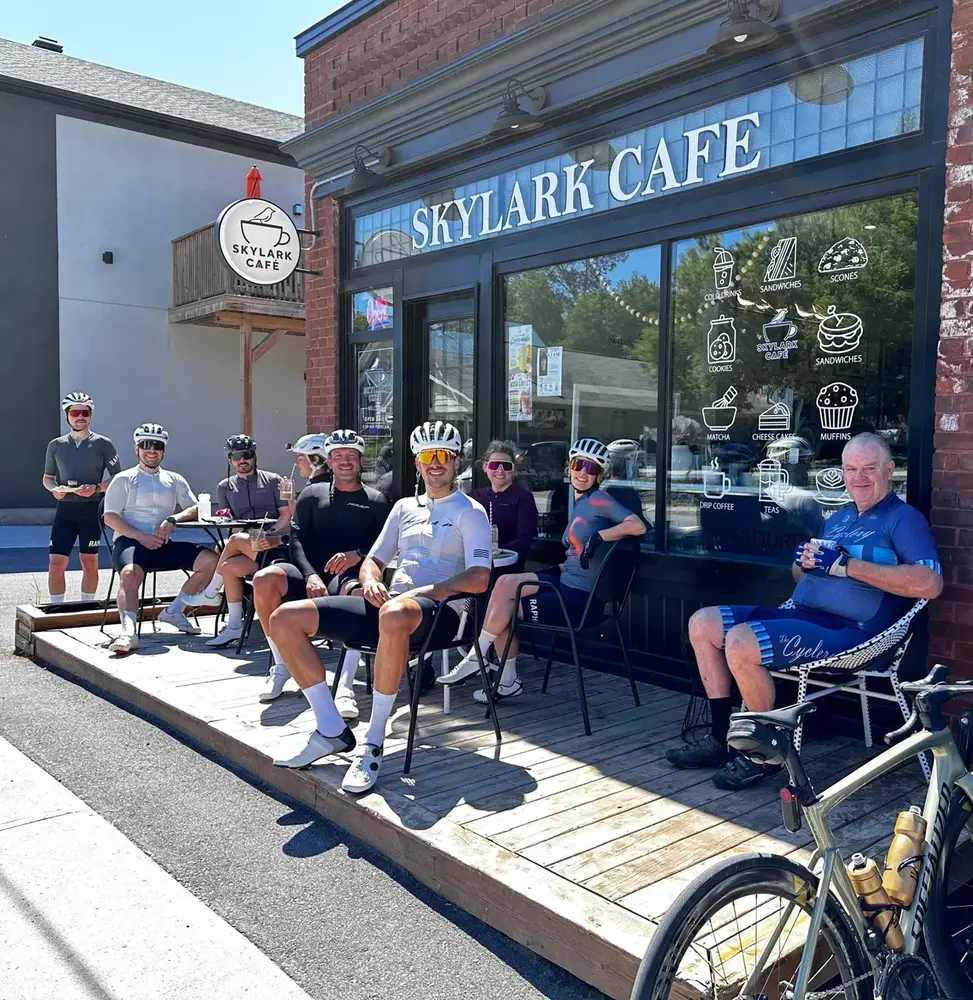 A group of cyclists relaxing on the patio outside Skylark Café